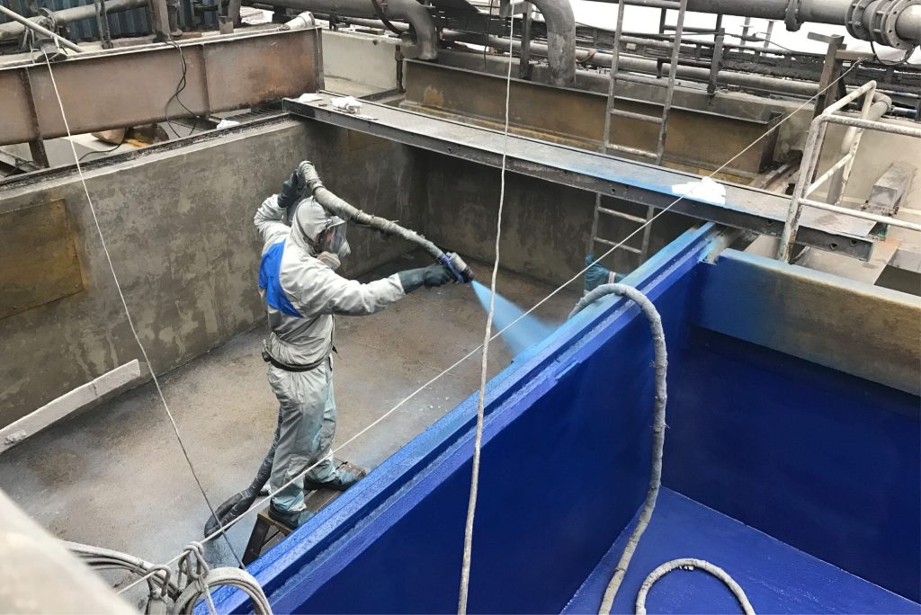 technician applying polyurea to concrete